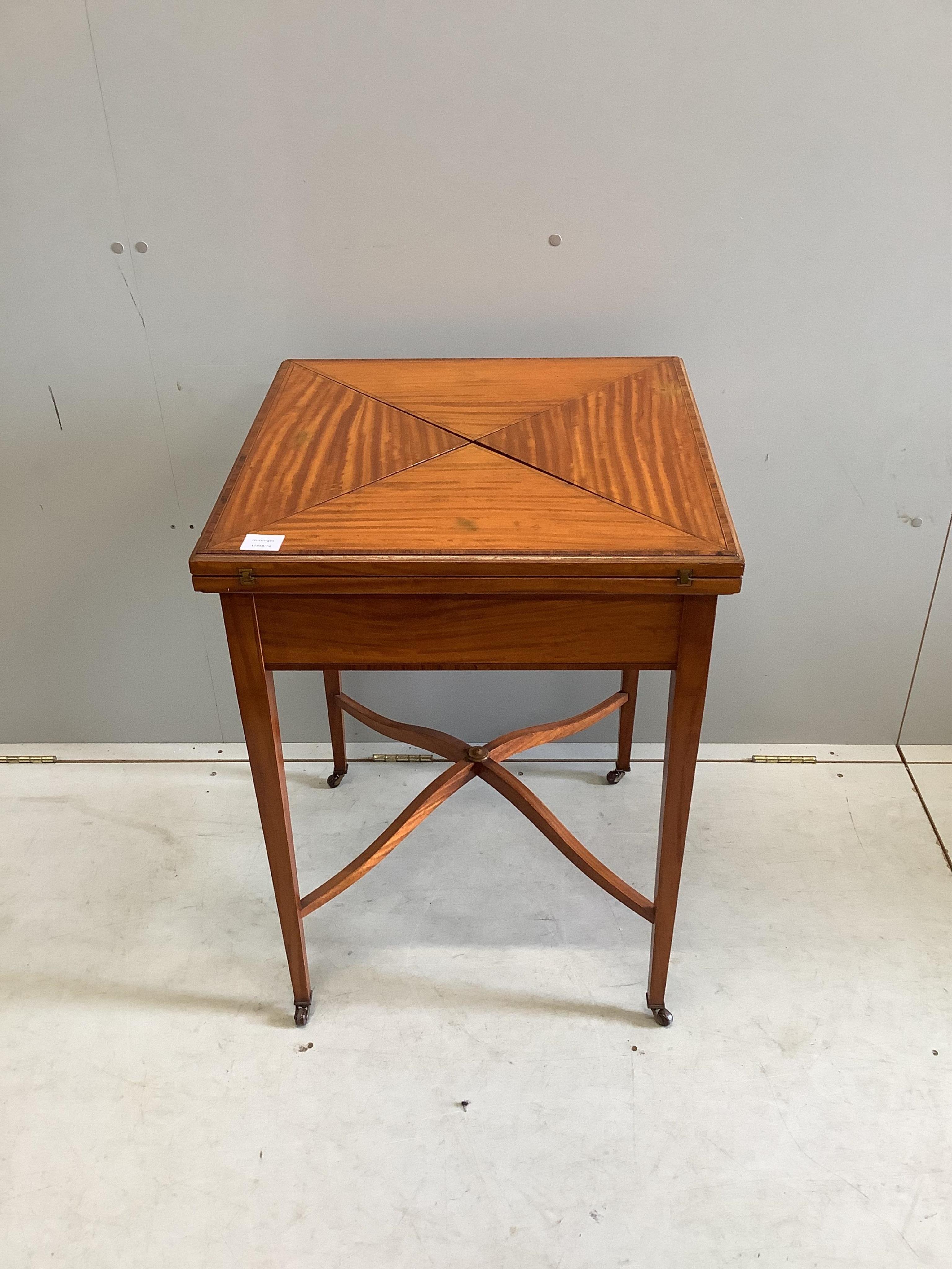 An Edwardian banded satinwood envelope card table, width 56cm, depth 56cm, height 76cm. Condition - good